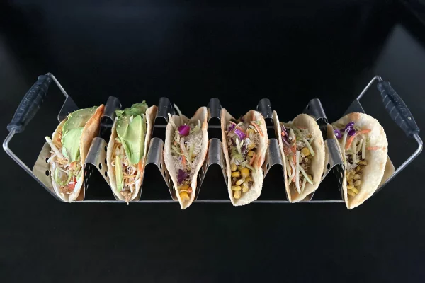 a tray of chicken tacos on a griddle surface