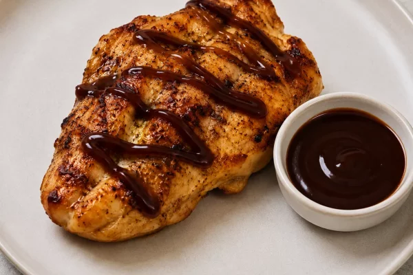 scored chicken breast with sauce